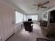 Sunroom features ample natural light, comfortable seating and a TV at 1871 Riveredge Dr, Astor, FL 32102