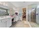 Elegant bathroom with double vanity and walk-in shower at 259 Cherokee Hill Ct, Deland, FL 32724