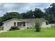 Tan single story house with a pool and a large yard at 1415 Talton Ave, Deland, FL 32720