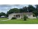 Tan single story house with a spacious yard at 1415 Talton Ave, Deland, FL 32720