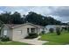 Tan single story house with a large yard and neighboring houses at 1415 Talton Ave, Deland, FL 32720
