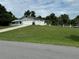 House with a large yard, a white fence, and a two-car garage at 1757 W Acadian Dr, Deltona, FL 32725