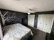 Bedroom with a dark-colored wall and a Parisian-themed bedspread at 1757 W Acadian Dr, Deltona, FL 32725