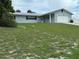 Single-story house with attached garage, and a large grassy yard at 1757 W Acadian Dr, Deltona, FL 32725