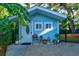 Inviting blue guest house with a private patio and tropical plants at 111 Fleming Ave, Port Orange, FL 32127
