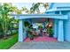Covered patio with seating area and abundant potted plants at 111 Fleming Ave, Port Orange, FL 32127