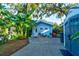 Quaint blue guest house with a private patio and lush landscaping at 111 Fleming Ave, Port Orange, FL 32127