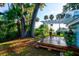 Peaceful backyard with a wooden deck, pergola, and tropical plants at 111 Fleming Ave, Port Orange, FL 32127