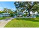 Light blue house with white picket fence and lush green grass at 111 Fleming Ave, Port Orange, FL 32127
