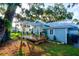 Charming cottage with a deck, pergola, and lush landscaping at 111 Fleming Ave, Port Orange, FL 32127
