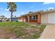 Brick home with a covered entryway and spacious lawn at 22 Morning Star Ave, Ormond Beach, FL 32176