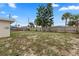 Large backyard with mature trees and wooden fence at 22 Morning Star Ave, Ormond Beach, FL 32176