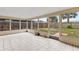 Spacious screened porch with tiled floor and backyard access at 22 Morning Star Ave, Ormond Beach, FL 32176