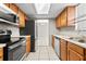 Modern kitchen with stainless steel appliances and wood cabinets at 22 Morning Star Ave, Ormond Beach, FL 32176