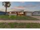 Brick ranch home with a one-car garage and manicured lawn at 22 Morning Star Ave, Ormond Beach, FL 32176