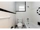 Bathroom with black and white tile and a tub at 22 Morning Star Ave, Ormond Beach, FL 32176