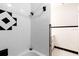White tiled bathroom with black accents and a tub at 22 Morning Star Ave, Ormond Beach, FL 32176
