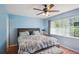 Spacious bedroom with light blue walls, king-size bed, and ceiling fan at 1987 S Old Mill Dr, Deltona, FL 32725