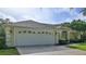 House exterior featuring a white garage door and landscaping at 3709 Donegal Cir, Ormond Beach, FL 32174