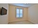 Bedroom with large window and wall-mounted TV at 3709 Donegal Cir, Ormond Beach, FL 32174