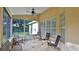 Screened porch with tile flooring and ceiling fan at 3709 Donegal Cir, Ormond Beach, FL 32174
