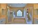 Elegant bathroom with soaking tub, walk-in shower, and glass block window at 3709 Donegal Cir, Ormond Beach, FL 32174