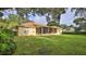 Large backyard with screened porch and mature trees at 3709 Donegal Cir, Ormond Beach, FL 32174