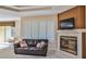 Cozy living room with fireplace and leather sofa at 3709 Donegal Cir, Ormond Beach, FL 32174