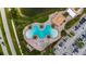 Community pool with surrounding lounge chairs and parking at 424 Luna Bella Ln # 428, New Smyrna Beach, FL 32168