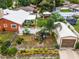 Aerial view of property showcasing home, detached garage, and yard at 980 Bluebird Ter, Deltona, FL 32725
