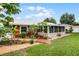Back exterior view of charming log cabin with screened porch at 980 Bluebird Ter, Deltona, FL 32725