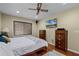 Spacious bedroom with hardwood floors, large TV, and ample storage at 980 Bluebird Ter, Deltona, FL 32725