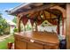 Relaxing hot tub in a covered gazebo with orange curtains at 980 Bluebird Ter, Deltona, FL 32725