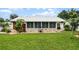 Rear house view, showcasing a sunroom and stonework at 980 Bluebird Ter, Deltona, FL 32725
