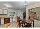 Open kitchen with breakfast bar and view into the dining room at 980 Bluebird Ter, Deltona, FL 32725