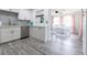 Updated kitchen with white cabinets, stainless steel appliances, and dining area at 2100 Brian Ave, South Daytona, FL 32119