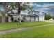 Charming two-story home with gray siding and blue accents at 2100 Brian Ave, South Daytona, FL 32119