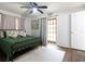 Main bedroom with green metal bed frame and access to backyard at 2100 Brian Ave, South Daytona, FL 32119