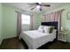 Bright bedroom with a queen-size bed and light pink curtains at 2100 Brian Ave, South Daytona, FL 32119
