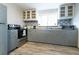 Modern kitchen with gray cabinets, stainless steel appliances, and a tile backsplash at 2100 Brian Ave, South Daytona, FL 32119
