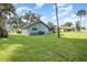 Back of house showing a large yard and screened porch at 573 Pelican Bay Dr, Daytona Beach, FL 32119