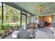 Relaxing screened porch with seating and dining areas at 573 Pelican Bay Dr, Daytona Beach, FL 32119