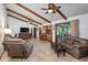 Spacious living area with hardwood floors, ceiling fan and access to backyard at 573 Pelican Bay Dr, Daytona Beach, FL 32119