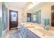 Clean bathroom with double vanity, shower, and access to backyard at 573 Pelican Bay Dr, Daytona Beach, FL 32119