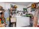 Interior laundry room with washer, dryer, utility sink, and storage shelves at 573 Pelican Bay Dr, Daytona Beach, FL 32119