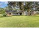 House exterior, showcasing a light blue home with stone accents at 573 Pelican Bay Dr, Daytona Beach, FL 32119
