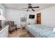 Bright bedroom with ceiling fan, dresser, and views of backyard at 573 Pelican Bay Dr, Daytona Beach, FL 32119