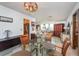 Charming dining room with glass table, hardwood floors and plenty of natural light at 573 Pelican Bay Dr, Daytona Beach, FL 32119