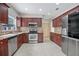 Modern kitchen with granite countertops and stainless steel appliances at 2291 Henry Ln, Deltona, FL 32738