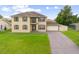Two-story house with large yard, driveway, and attached garage at 2291 Henry Ln, Deltona, FL 32738